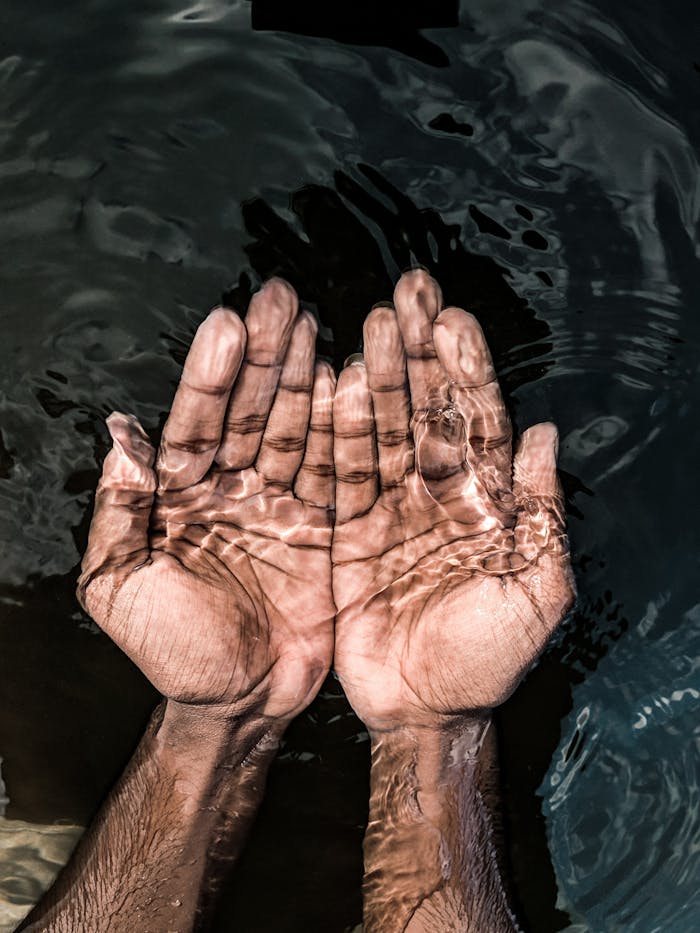 pexels-photo-4515858 From above of crop anonymous male washing hands in clean water of lake in daytime